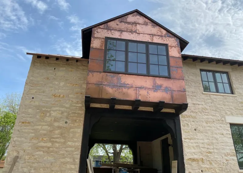 Copper metal panel facade on a stone building for Skylight Installation in Lovington
