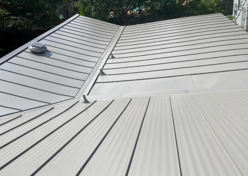 Solar attic fan installed on a metal roof for Roof Ventilation in Lovington